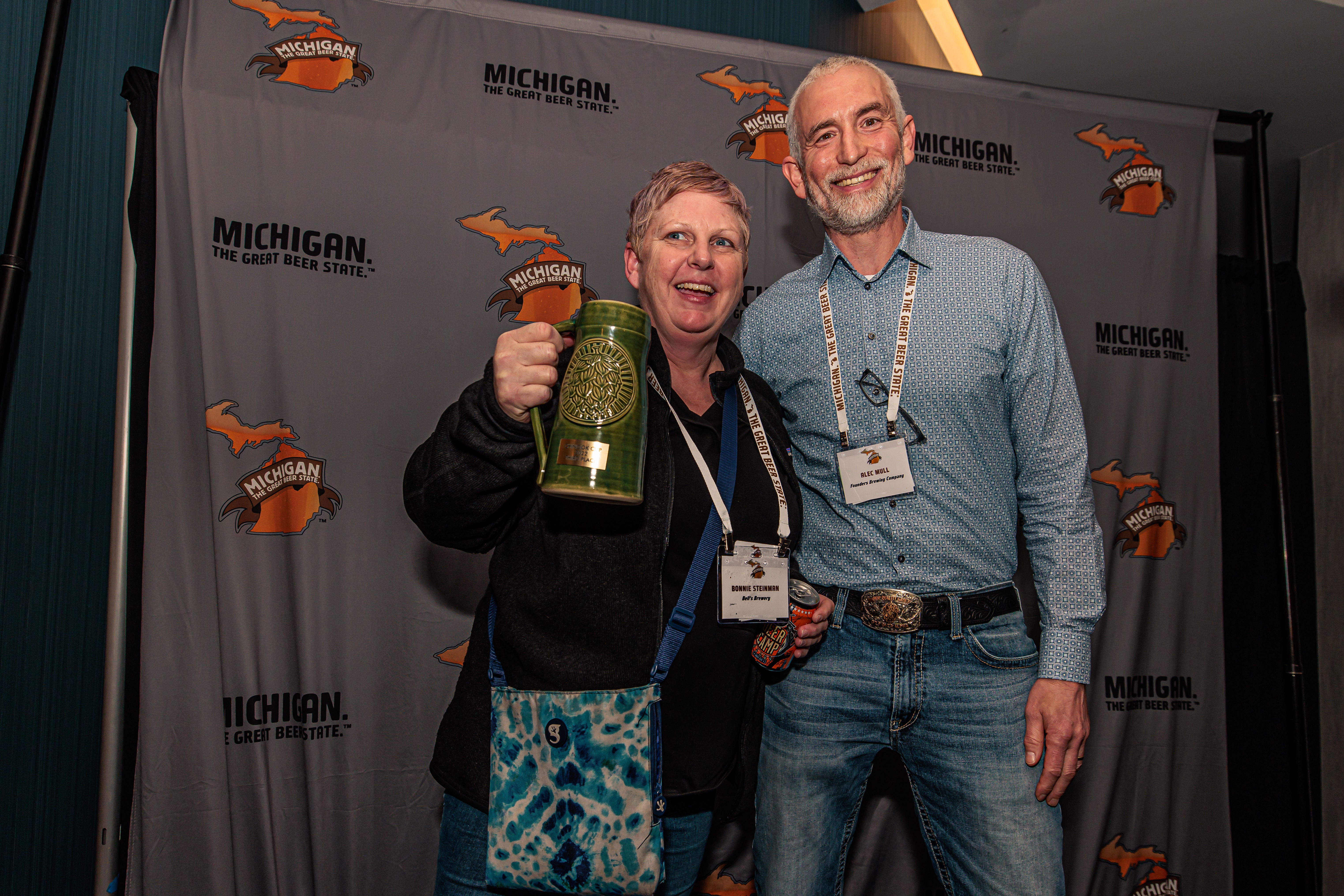 A man presents a woman with a trophy.